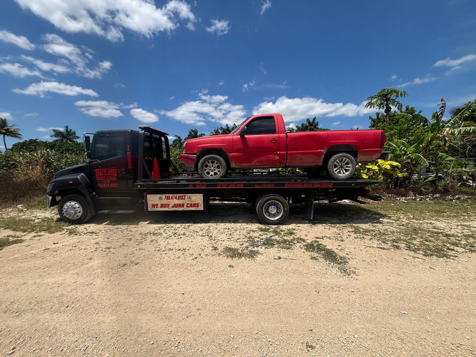 Bueno Towing Service tow truck transporting a vehicle